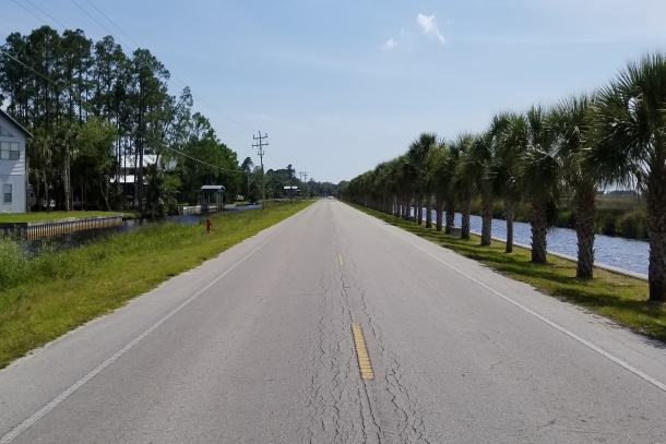 Road into town. Gulf waters on the right, river on the left